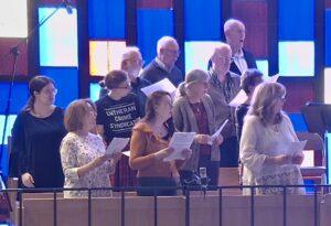 Cheshire Lutheran Church choir singing "Many Gifts, One Spirit" with Martha Medford accompanying on organ during the October 18, 2026 worship service